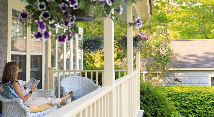 Woman reading on a chair on a private patio