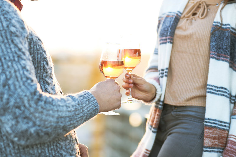 Couple toasting with wine outside