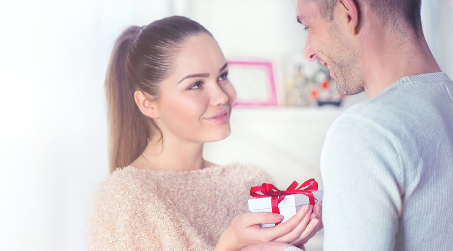 Romantic couple exchanging gifts