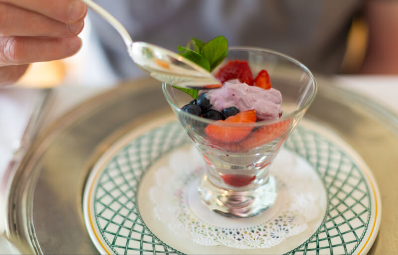 Fresh berries and yogurt with silver platter