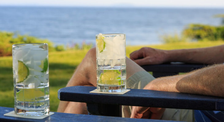 Refreshing cocktail on the arm of a beach chair