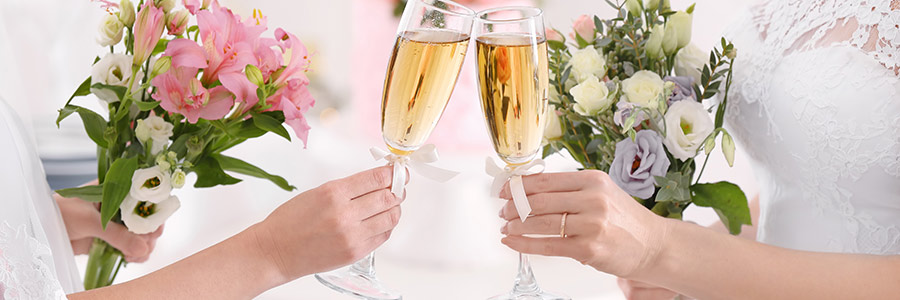 two brides toasting with champagne