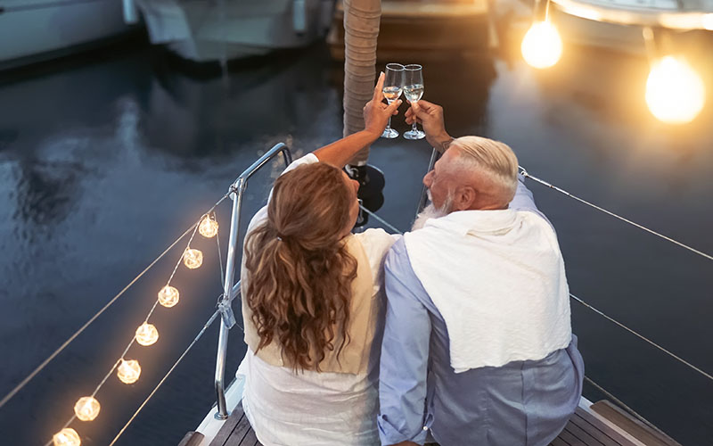 newly married couple sailing with champagne