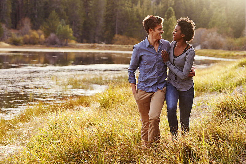 couple hiking by lake in Maine