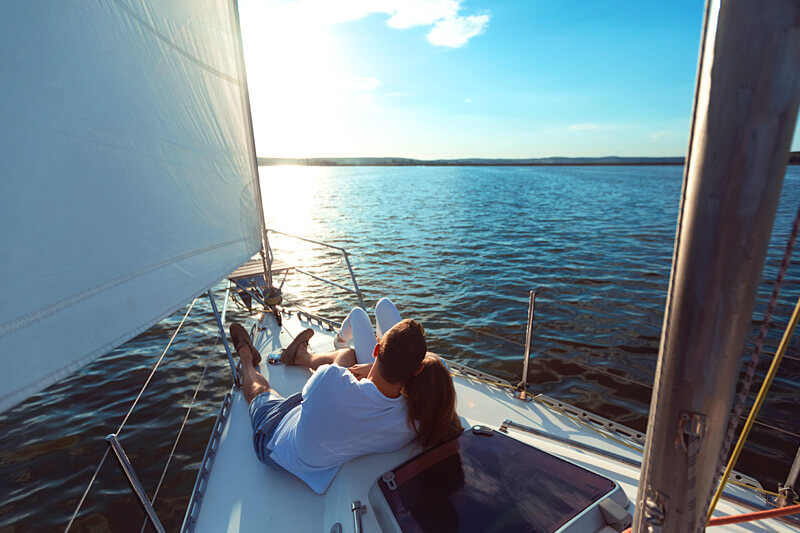 couple snuggling on sailboat in Maine