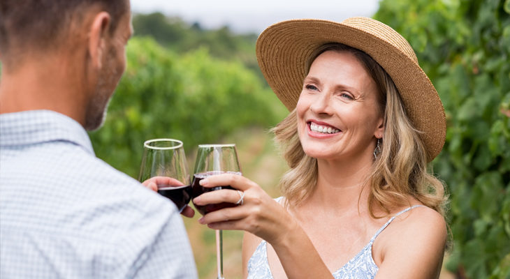 a couple wine tasting at a vineyard